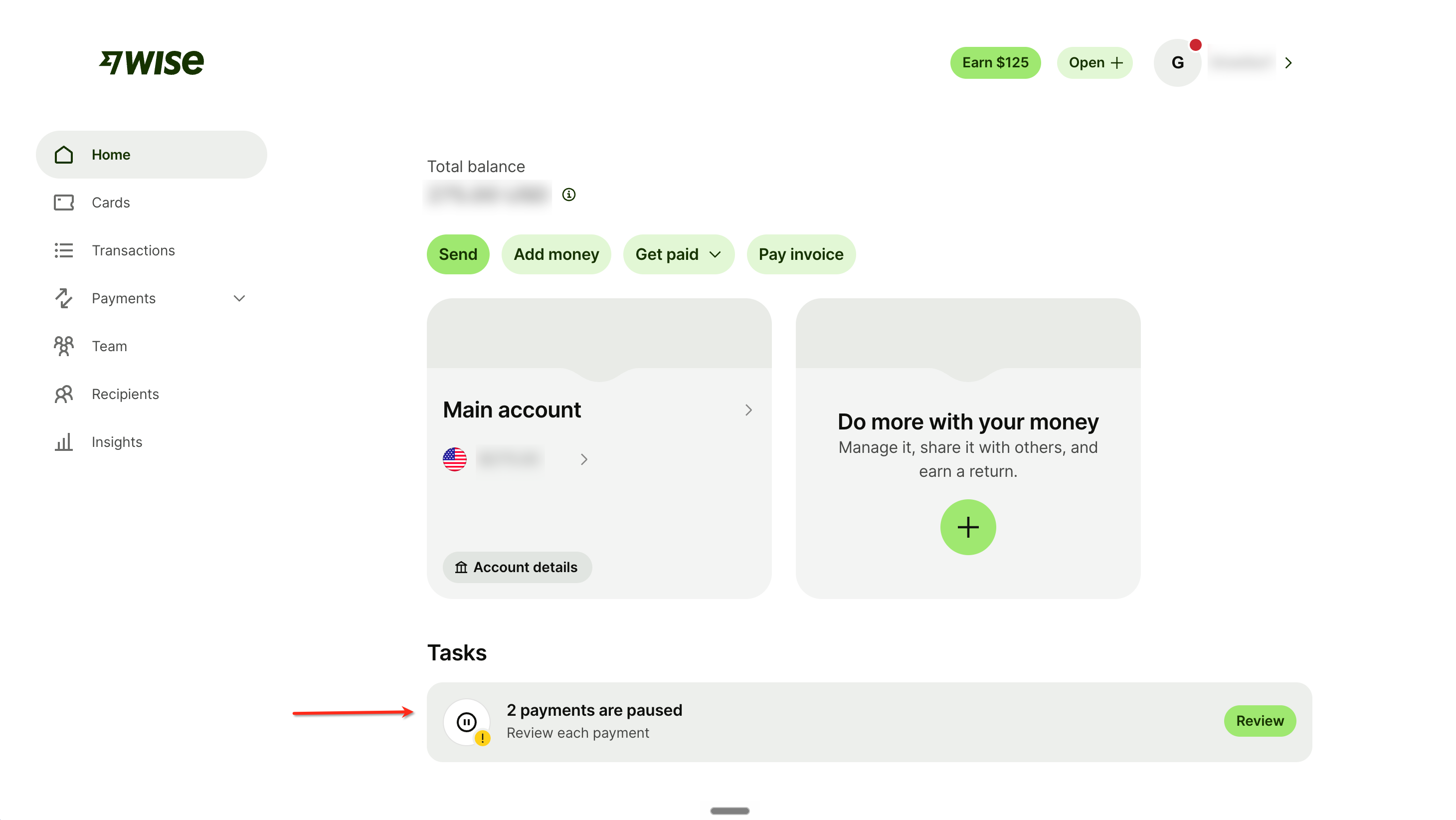 The Wise home page with the paused payments task highlighted